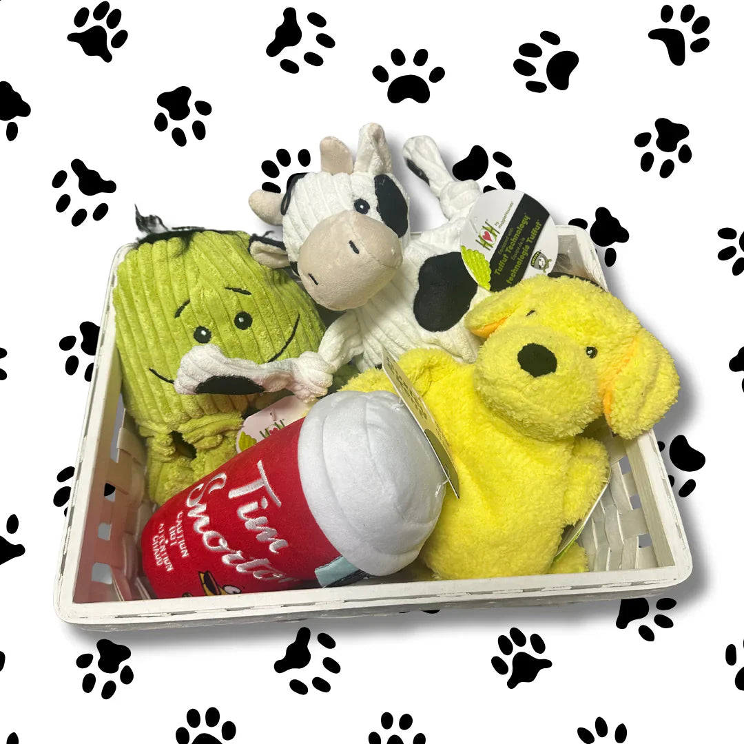 Set of plush toys including a cow, dog, and giraffe in a box on a white background with black paw prints.