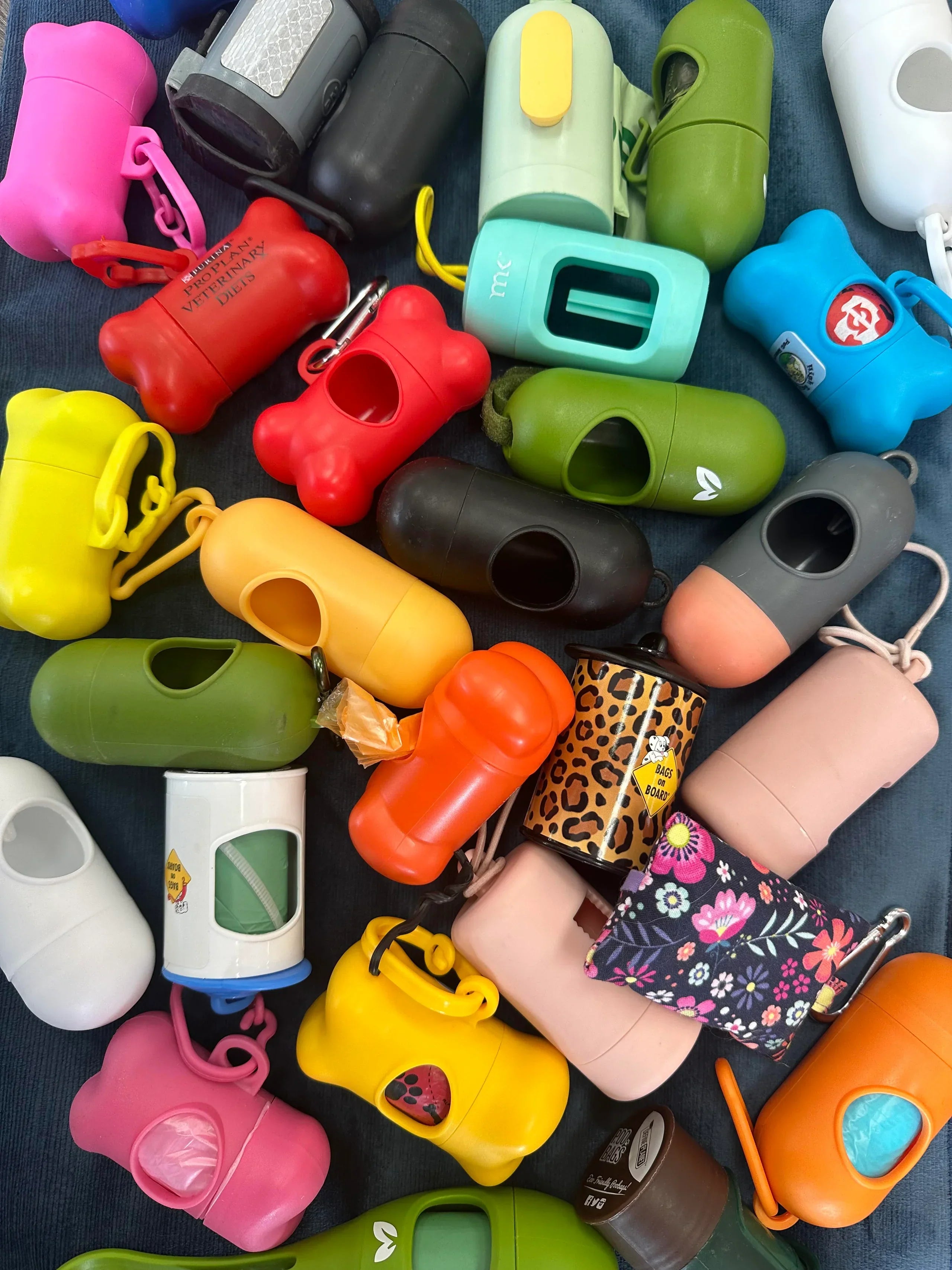 Assorted colorful keychains and pouches on a dark surface