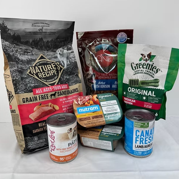 Assorted dog food products including bags and cans on a white background