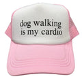 Pink and white cap with 'dog walking is my cardio' text on a white background